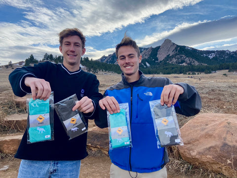 Hunter and Cayce posing in front of Boulder Flatirons