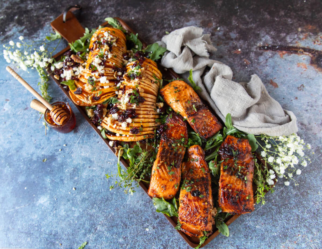 A spread of cooked salmon and leafy garnish.
