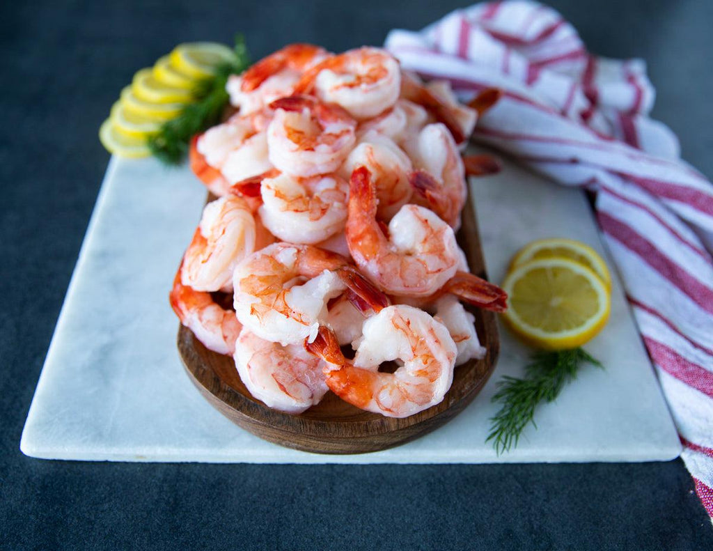 Tiger prawns shrimps roasted on frying grill pan with green sauce, lemon  and garlic on wooden background - SuperStock