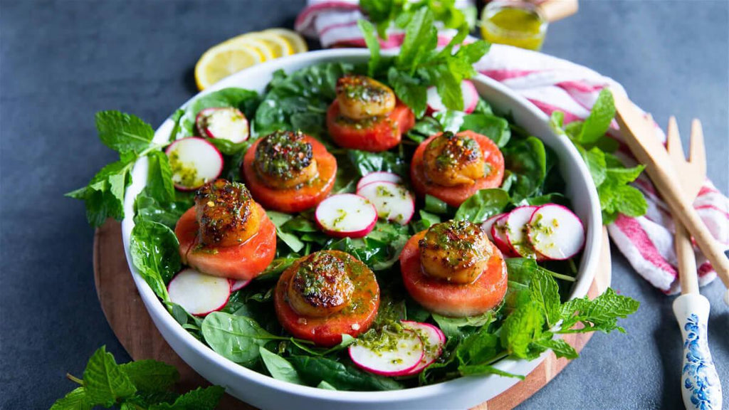 A healthy meal of Scallops On A Watermelon Salad With Mint Vinaigrette