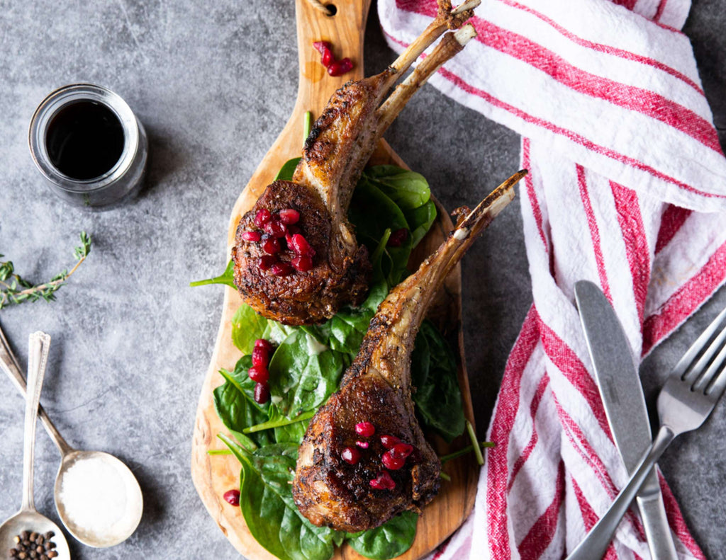 Sealand Quality Foods French Cut Lamb Rack on Cutting Board with Cranberries