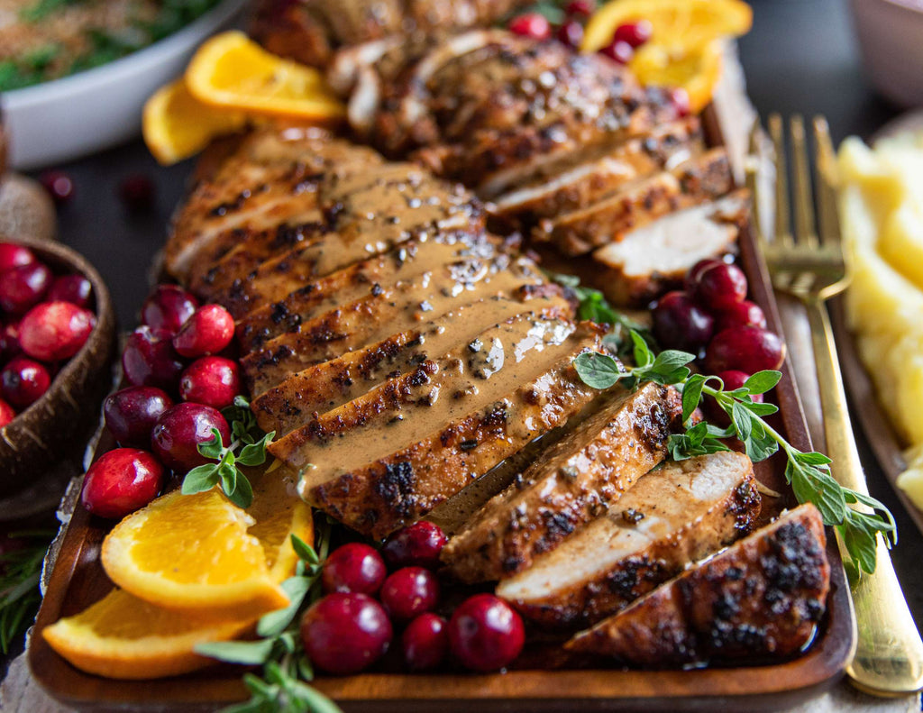 Sealand Quality Foods Turkey Tenderloin Sliced on Cutting Board with Cranberries