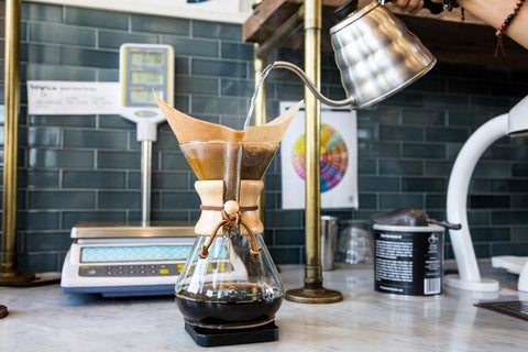 Pouring hot water into Chemex Coffee brewer