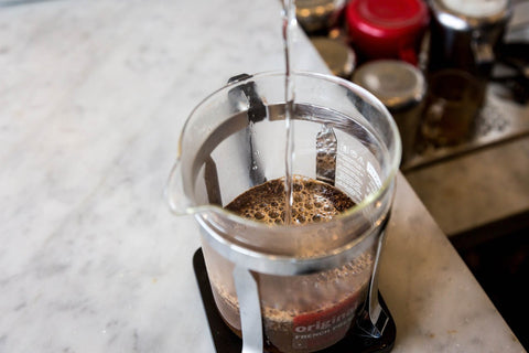 pouring coffee into a French press