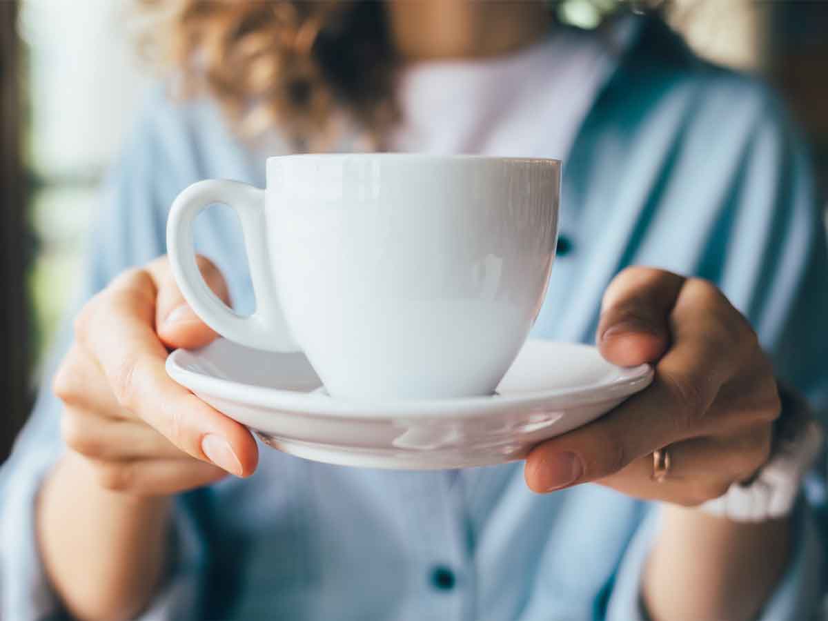 woman is offering a cup of tea