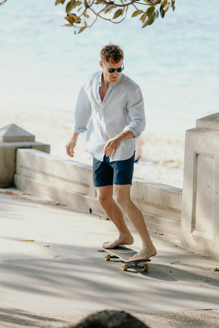 man on skateboard wearing board shorts