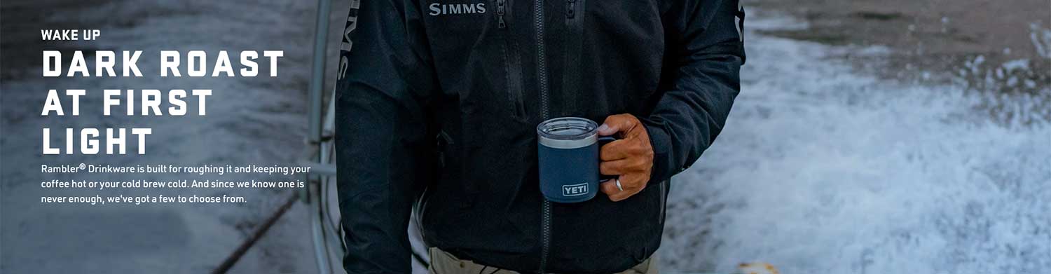 picture of a male outdoor enthusiast holding a YETI coffee mug
