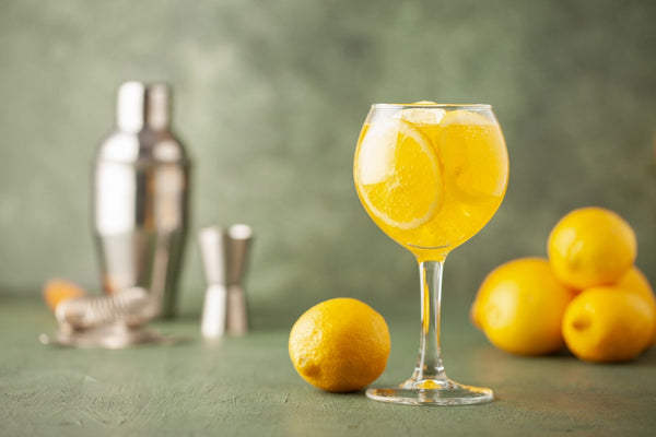 limoncello cocktail with lemons and bar tools