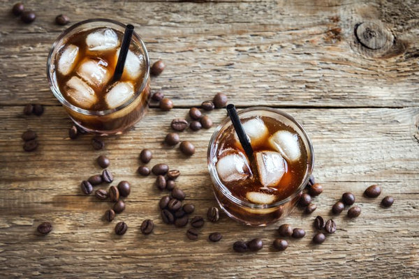 two black russian cocktails from above with coffee beans