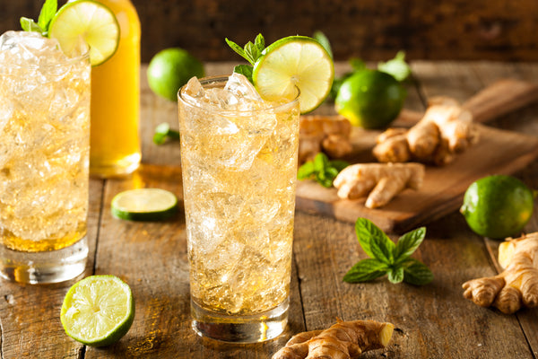 two glasses of ginger beer with lime mint and ice