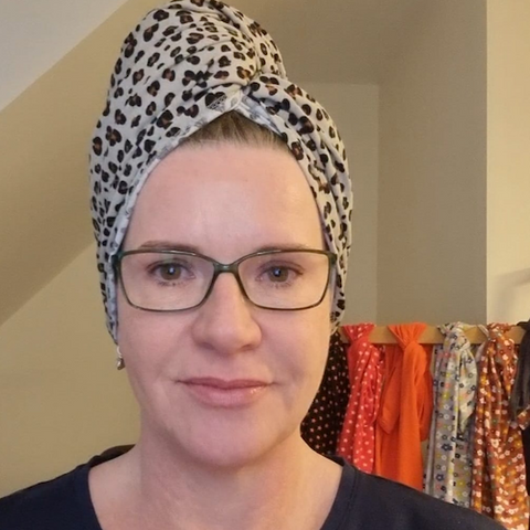 Good Wash Day founder Karen Saull in one of her leopard print hair towels.