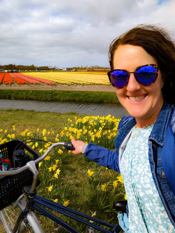 girl on a bike in tulip fields