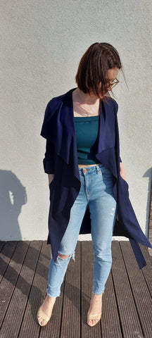 lady in jeans, navy blue cardigan and emerald green corset top