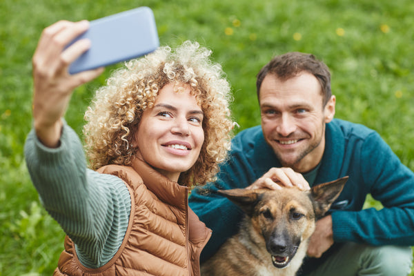 Couple taking a selfie with their dog