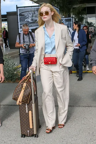 Elle Faninng with Louis Vuitton luggage