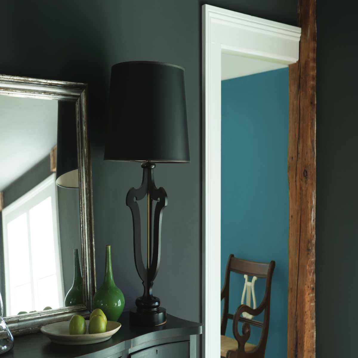 Mirror with Black table lamp kept on side