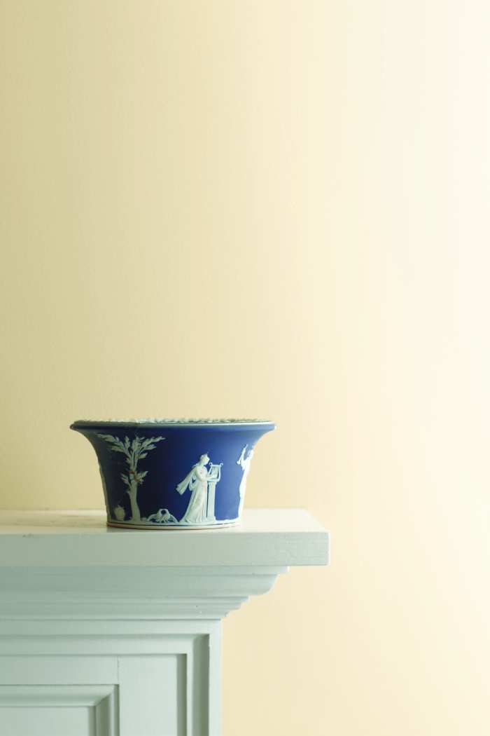 edge of a mantle with a decorated bowl resting on top