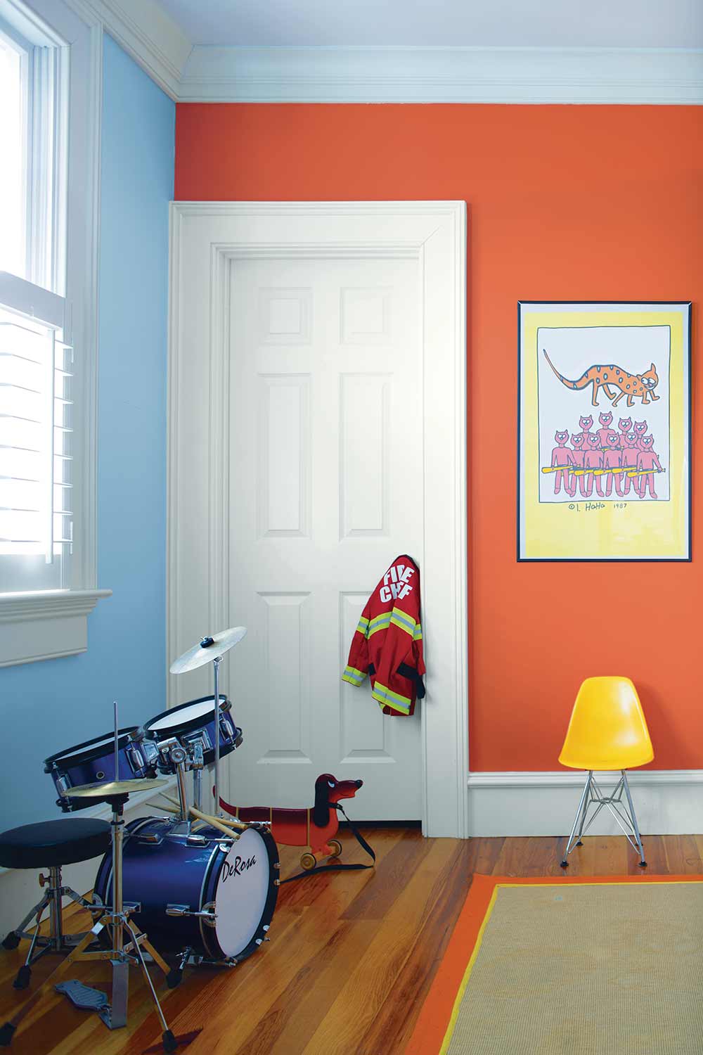 orange and blue kids bedroom with a drumset
