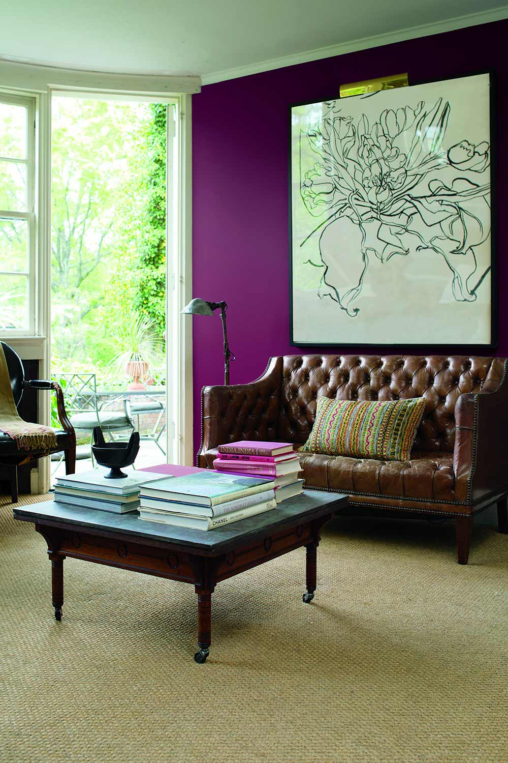living room with a large window and bright purple wall