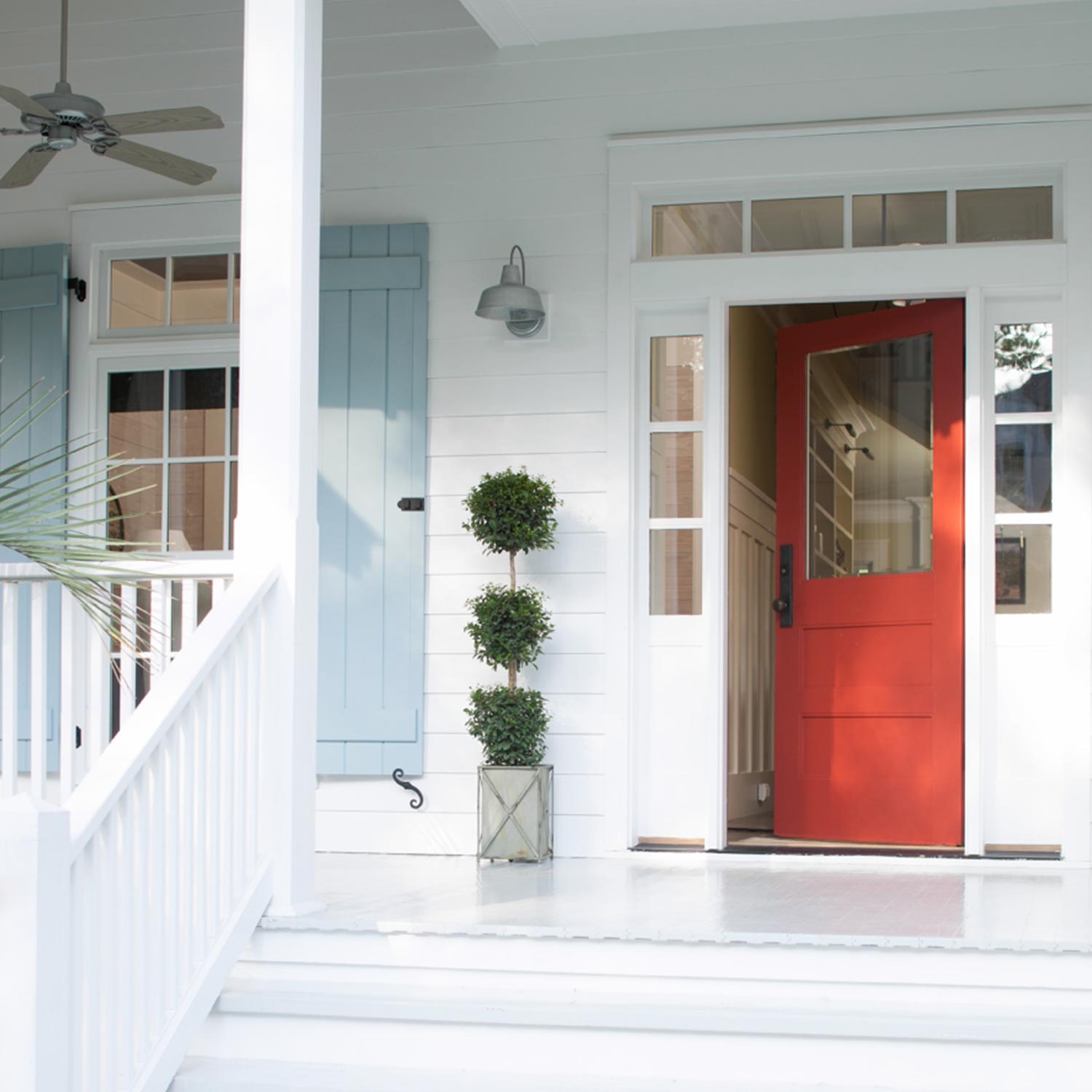 white porch with a red door