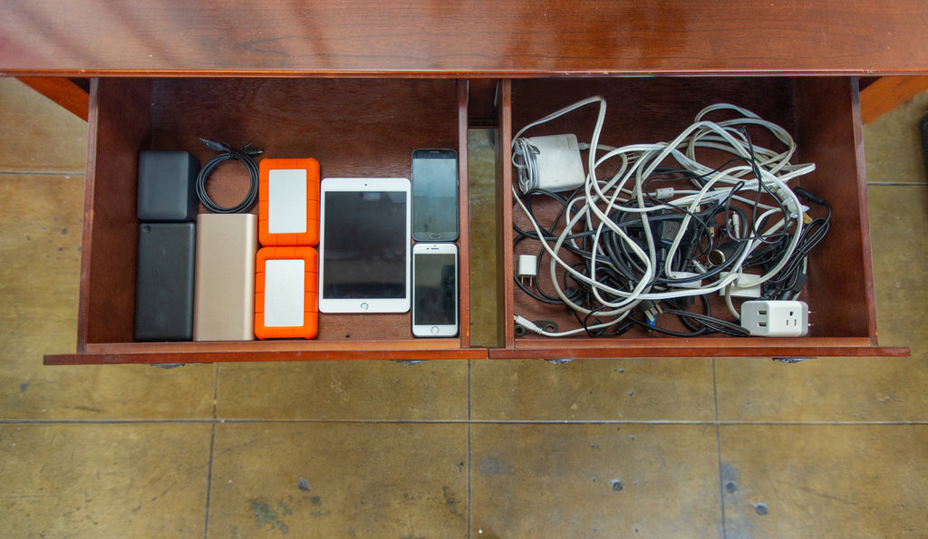 Hard drives, tablet, smart phone and chargers in two drawers