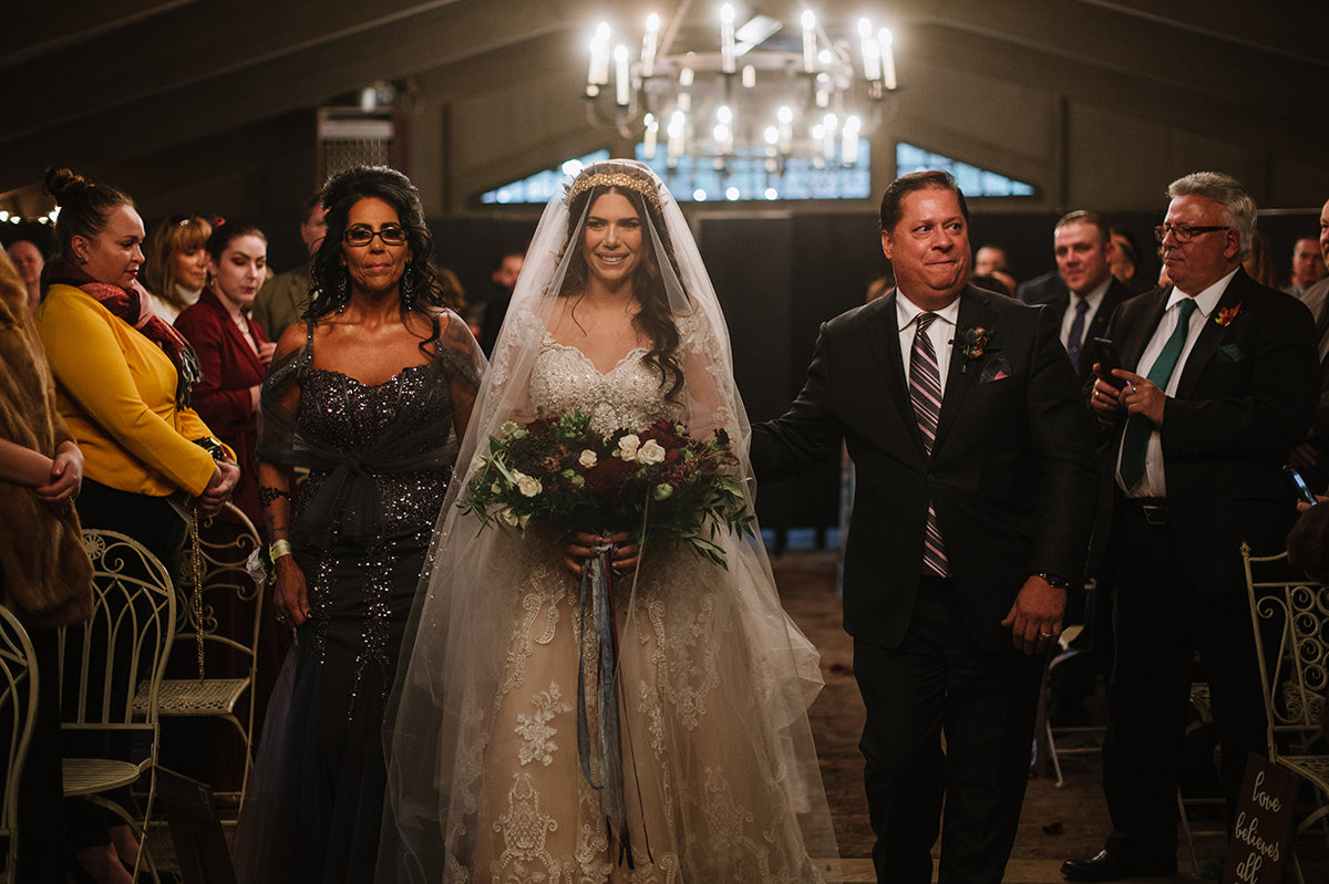 beautiful bride in wedding gown and cathedral veil with gold amaroq bridal headpiece crown