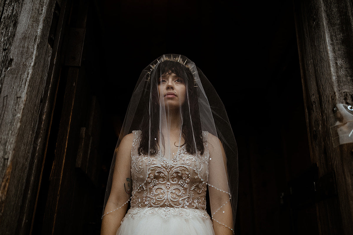 bride in short peep veil and wedding gown with amaroq gold headpiece crown