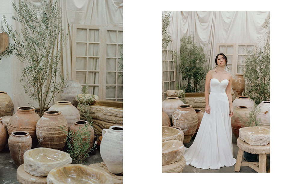 Model wears strapless white dress in a gallery of antique pots in Los Angeles