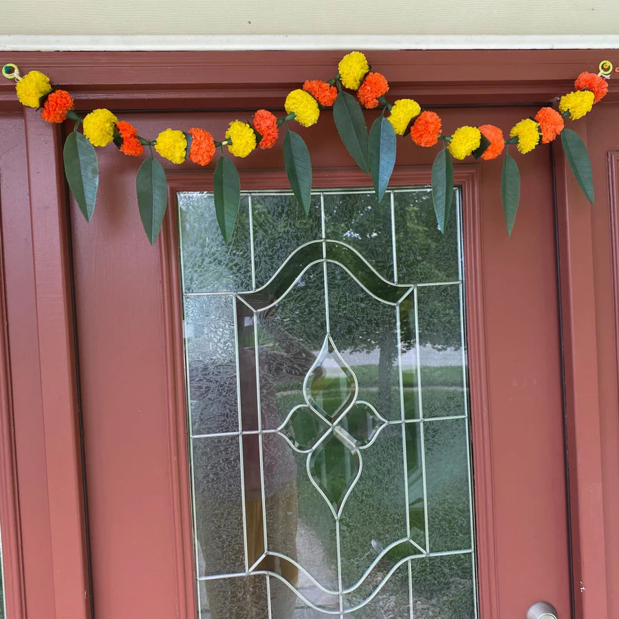 Hanging floral garlands, or torans, crafted from marigolds, jasmine, or mango leaves swing gently above doorways is very popular during Navratri.