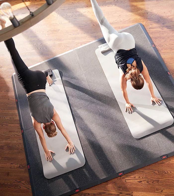 Two women doing yoga on AnjiMTX mat