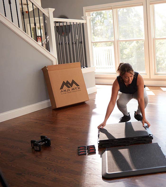 Woman assembling AnjiMTX exercise mat