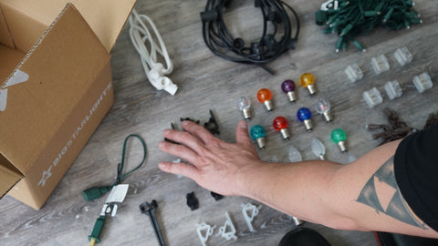 Person sorting through a sample kit of Commercial Christmas light supplies