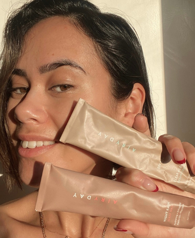 Airyday girl holding aluminium SPF skincare tubes