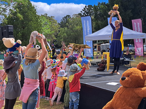 Little_Ballet_Dancer_teacher_Miss_Debbie_is_dancing_in_front_of_a_crowd_of_young_children_everyone_is_dancing_along_with_their_teddy_bears