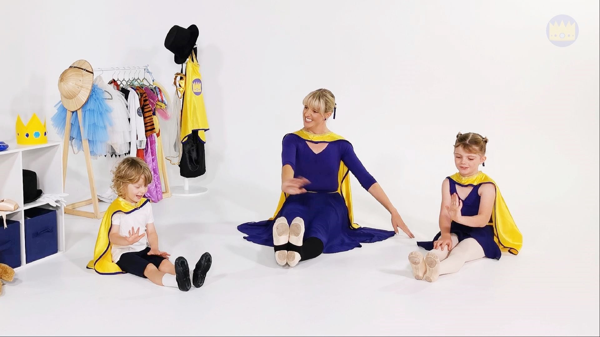 A toddler and preschooler join ballet teacher Miss Debbie for an exercise to strengthen their toes