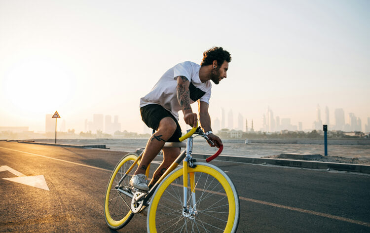 a man rides a white-yellow bike on the road