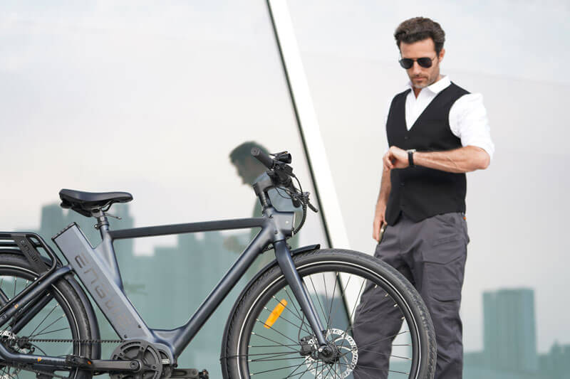 a man standing next to an engwe p275 pro commuter bike