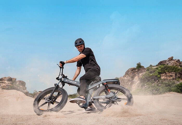 a man rides an engwe x26 ebike on the sand