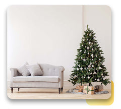 A beautiful white sofa beside a Christmas tree.