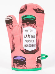 A pink oven mitt displaying the phrase "Bitch I Am The Secret Ingredient" prominently.