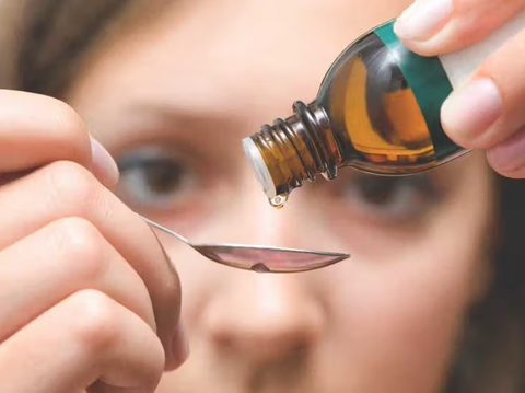 Lady Pouring Colloidal Silver Drops