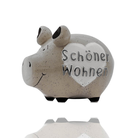 Sparschwein mit einem Herz und der Aufschrift Schöner Wohnen. Die Spardose ist ein schönes Dekoelement und hilft beim Sparen auf das nächste schöne Dekoelement für Deine Wohnung.