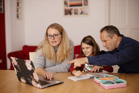 A couple is teaching a child to learn