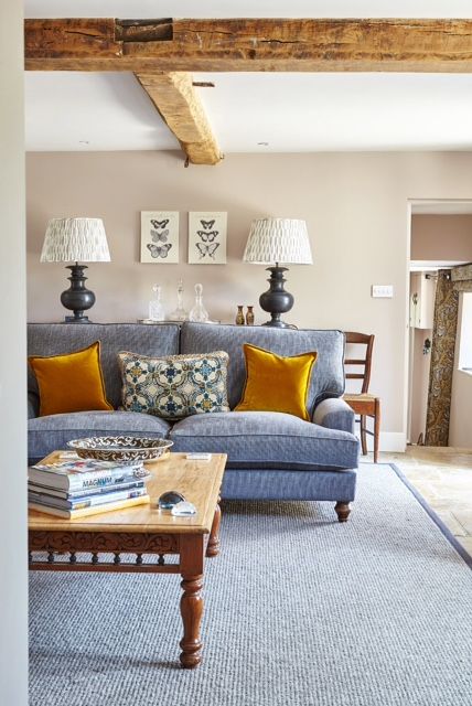 JH Designs' sitting room featuring Pooky's Verona wooden table lamps in chocolate with shade in block-printed cotton