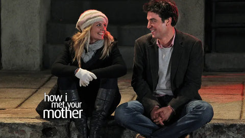 A photograph from the sitcom How I met Your Mother with the character Ted Moseby and Zoey sitting together on the pavement used - The Bicyclist