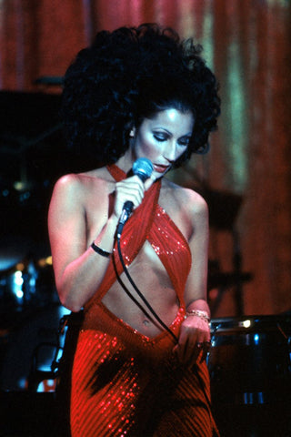Cher wearing a red sequin wrap dress