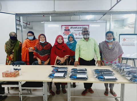 Reemi distributing period underwear with Hop Lun in garment factory in Bangladesh