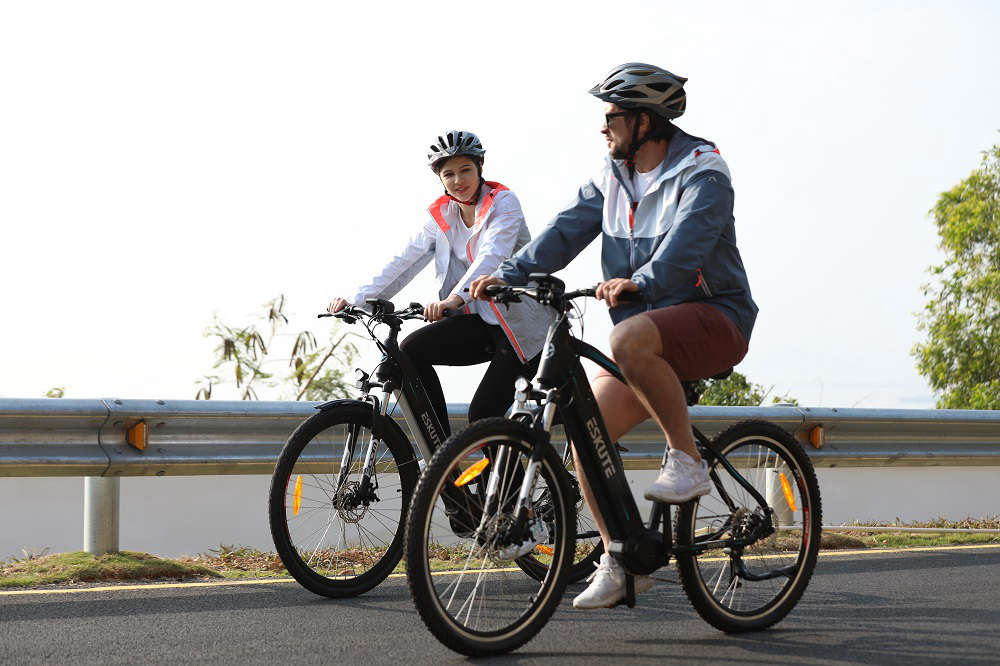 Ein Paar trägt Helme, wenn es E-Bikes fährt