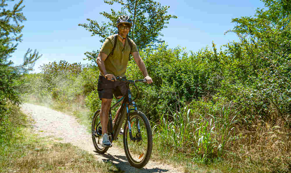 der männliche Fahrer hält die Bremshebel fest am Fahrrad