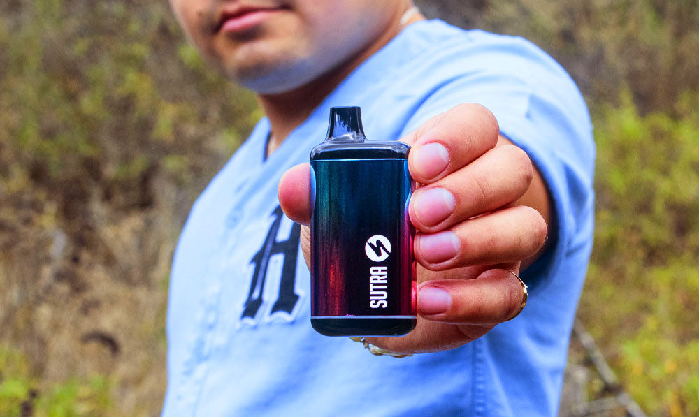 Man holding Sutra SILO Pro in front of a park trail